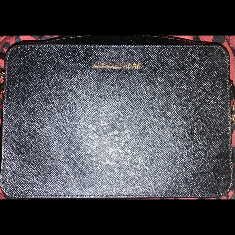 Black cross body with gold link parts on the strap